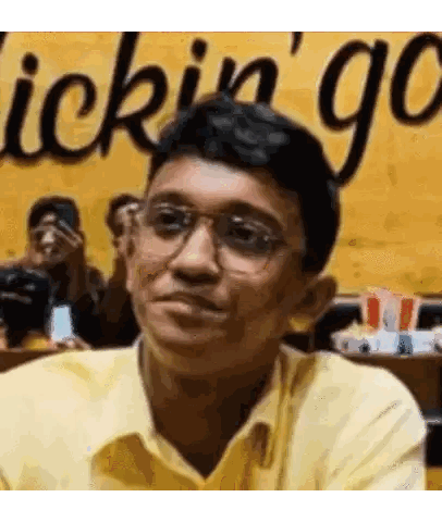 A Man Wearing Glasses Is Sitting In Front Of A Sign That Says Quick N ' Go Sticker