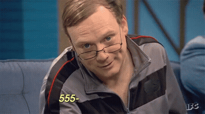 A Man Wearing Glasses Is Sitting On A Couch And The Number 555 Is On The Screen GIF
