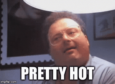 A Man Wearing Glasses Is Sitting Under A Light And Says `` Pretty Hot '' . GIF