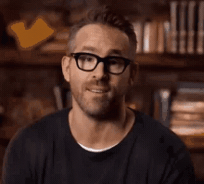 A Man Wearing Glasses Is Smiling And Asking Who Are They . GIF