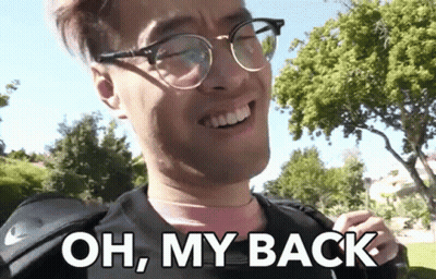 A Man Wearing Glasses Is Smiling And Says Oh My Back GIF