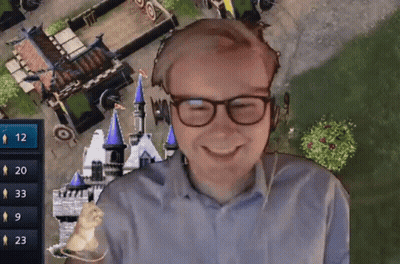 A Man Wearing Glasses Is Smiling In Front Of A Video Game Screen With The Number 12 On It GIF