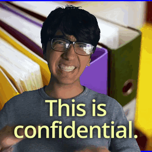 A Man Wearing Glasses Is Smiling In Front Of Binders That Say This Is Confidential GIF