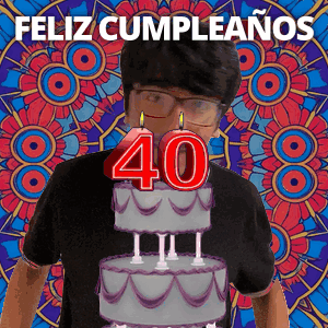 A Man Wearing Glasses Is Standing In Front Of A Birthday Cake With The Number 40 On It GIF