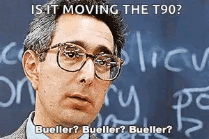 A Man Wearing Glasses Is Standing In Front Of A Chalkboard With The Words Is It Moving The T90 Written On It GIF