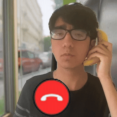 A Man Wearing Glasses Is Talking On A Phone With A Red Circle With The Letter C In It GIF