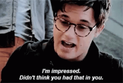 A Man Wearing Glasses Is Talking To Another Man . GIF