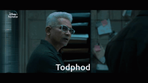 A Man Wearing Glasses Is Talking To Another Man And The Word Todphod Is On The Screen GIF