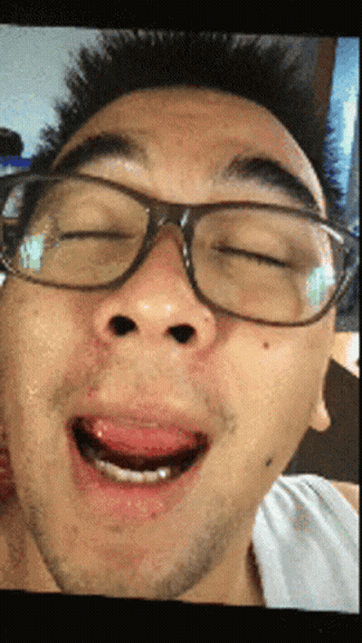 A Man Wearing Glasses Making A Funny Face With His Mouth Open GIF