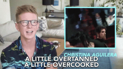 A Man Wearing Glasses Says Christina Aguilera A Little Over Tanned A Little Overcooked GIF