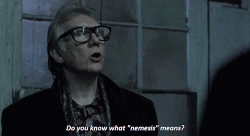 A Man Wearing Glasses Says Do You Know What Nemesis Means GIF