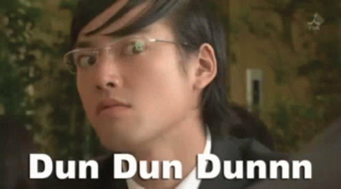 A Man Wearing Glasses Says Dun Dun Dunnn On The Bottom Of His Face GIF