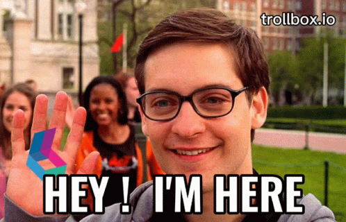 A Man Wearing Glasses Says Hey I 'M Here In Front Of A Group Of People GIF