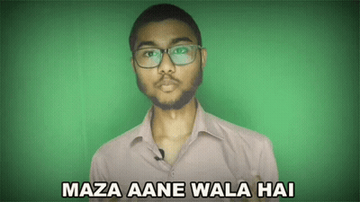 A Man Wearing Glasses Says Maza Aane Wala Hai On A Green Background GIF