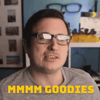 A Man Wearing Glasses Says " Mmmm Goodies " In Yellow GIF