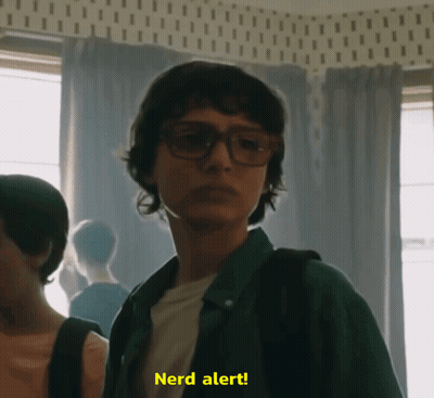 A Man Wearing Glasses Says Nerd Alert GIF