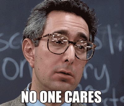 A Man Wearing Glasses Says No One Cares In Front Of A Chalkboard GIF