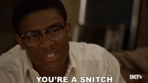 A Man Wearing Glasses Says " You 'Re A Snitch " GIF