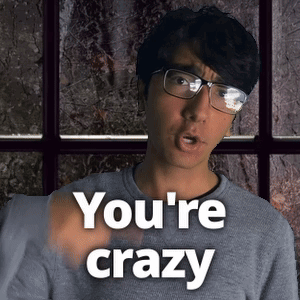 A Man Wearing Glasses Says You 'Re Crazy In Front Of A Window GIF