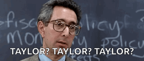 A Man Wearing Glasses Stands In Front Of A Blackboard That Says Bueller GIF