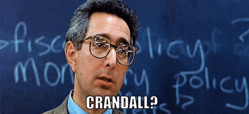 A Man Wearing Glasses Stands In Front Of A Blackboard That Says Crandell On It GIF