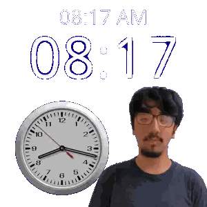 A Man Wearing Glasses Stands In Front Of A Clock That Says 8:17 Am Sticker