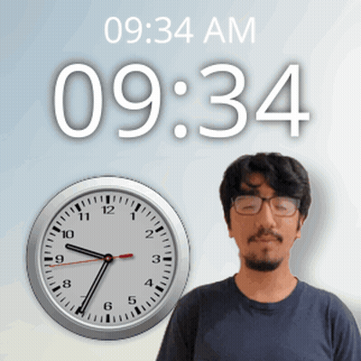 A Man Wearing Glasses Stands In Front Of A Wall Clock That Says 09:34 Am GIF