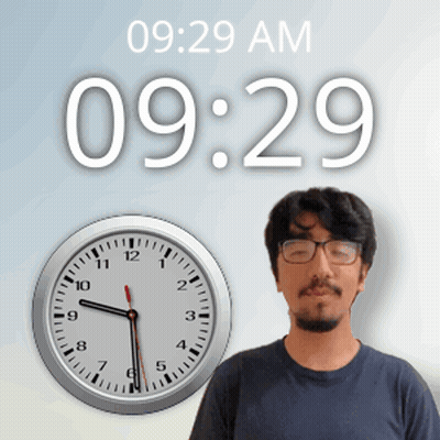 A Man Wearing Glasses Stands In Front Of A Wall Clock That Says 10:29 Am GIF