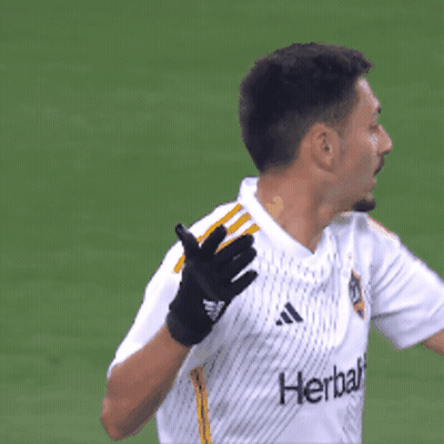 A Man Wearing Gloves And A Shirt That Says Herbalife GIF
