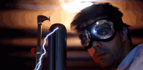 A Man Wearing Goggles And A Mask Looks At A Lightning Bolt GIF