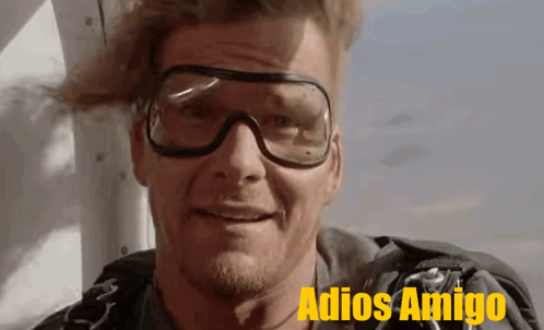 A Man Wearing Goggles Says Adios Amigo On The Bottom Right GIF