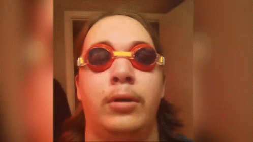 A Man Wearing Goggles With The Words It Is Wednesday On The Bottom GIF