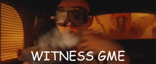 A Man Wearing Goggles With The Words Witness Gme Written On The Bottom GIF