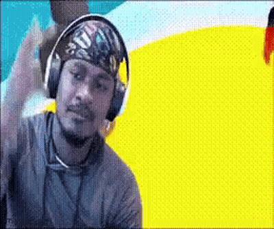 A Man Wearing Headphones And A Bandana Has A Yellow And Blue Background GIF
