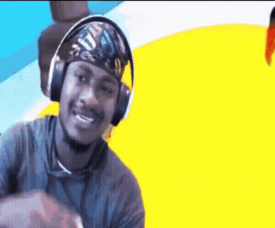 A Man Wearing Headphones And A Bandana Is Smiling . GIF