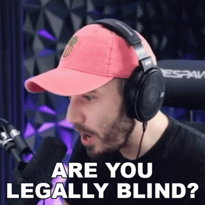 A Man Wearing Headphones And A Baseball Cap Is Talking Into A Microphone And Asking If He Is Legally Blind . GIF