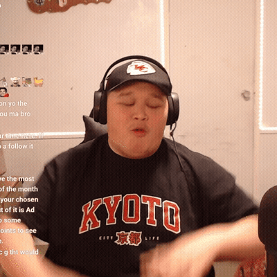A Man Wearing Headphones And A Black Shirt That Says Kyoto On It GIF