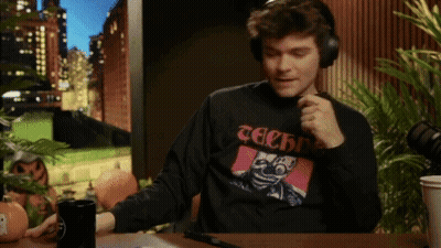 A Man Wearing Headphones And A Black Shirt That Says Techno GIF