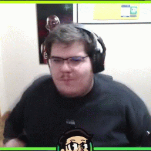 A Man Wearing Headphones And A Black Shirt With A Picture Of A Man On It GIF