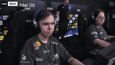 A Man Wearing Headphones And A Black Shirt With Red Bull On It GIF