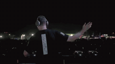 A Man Wearing Headphones And A Black Shirt With The Number 1 On The Back GIF