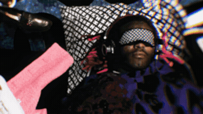 A Man Wearing Headphones And A Blindfold With The Letter N On It GIF