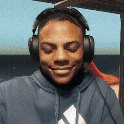 A Man Wearing Headphones And A Blue Adidas Sweatshirt Smiles GIF