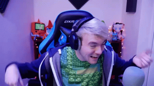 A Man Wearing Headphones And A Blue Dxr Chair GIF