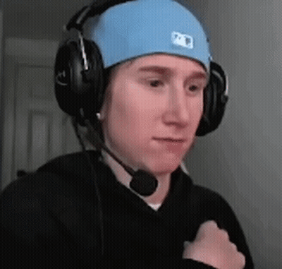 A Man Wearing Headphones And A Blue Hat With A Microphone On His Head . GIF