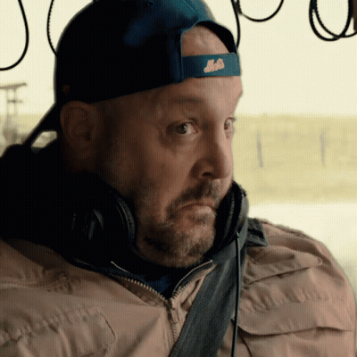 A Man Wearing Headphones And A Blue Hat With The Word Mets On It GIF