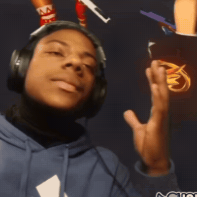 A Man Wearing Headphones And A Blue Hoodie With A White Triangle On The Front GIF
