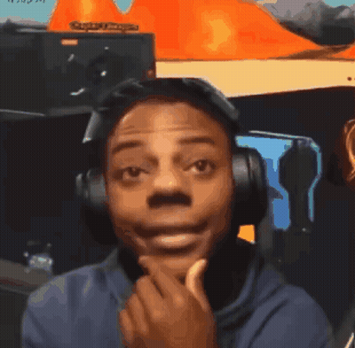 a man wearing headphones and a blue shirt is making a face