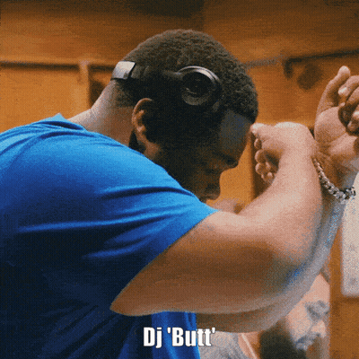 A Man Wearing Headphones And A Blue Shirt Says " Dj Butt " On The Bottom GIF