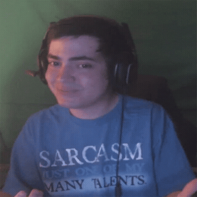 A Man Wearing Headphones And A Blue Shirt That Says Sarcasm On It GIF